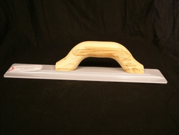 Wooden concrete float with a smooth handle for leveling and finishing cement surfaces.